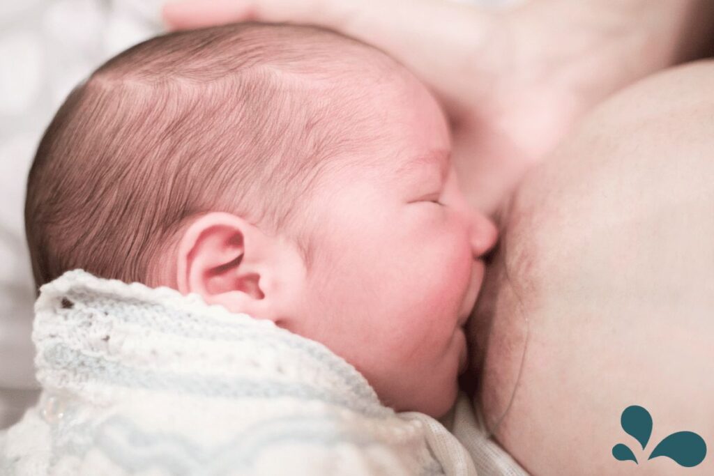 Baby breastfeeding with a nipple shield.